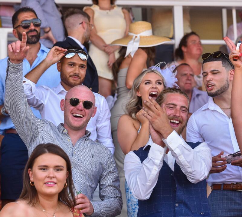 A group of guys in the crowd enjoying the racing at Southwell