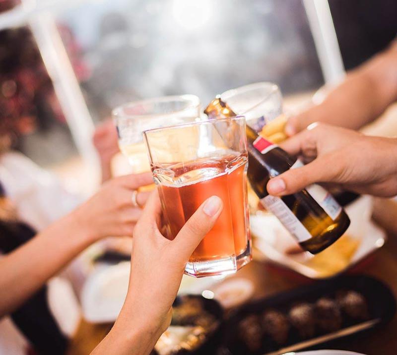 Friends raising a drink together.