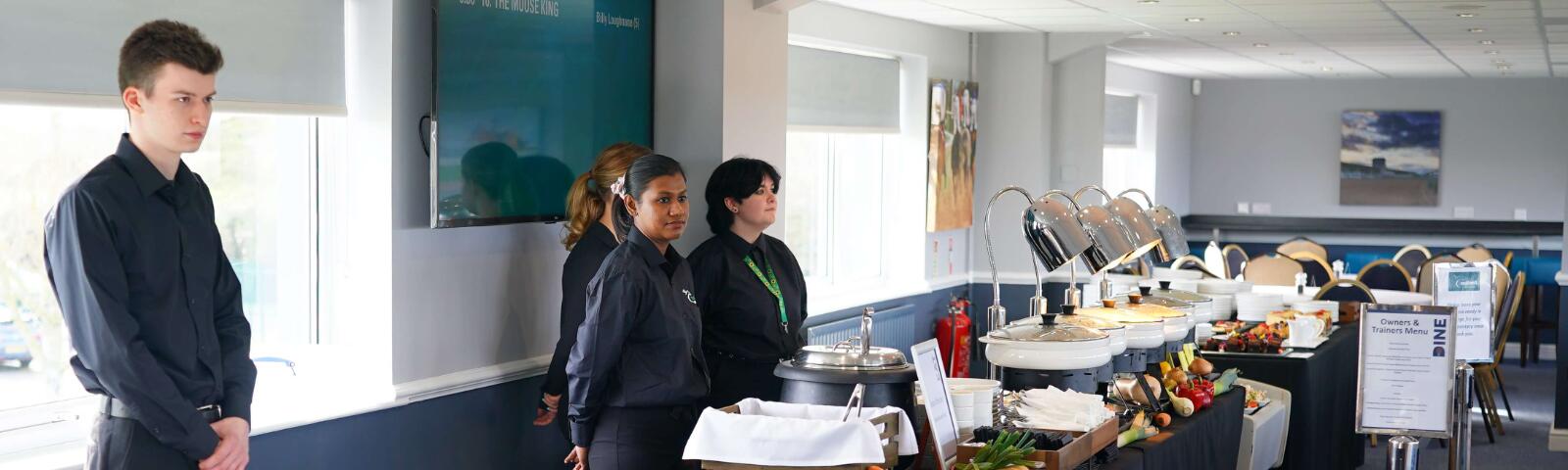 Catering staff at Southwell Racecourse wait for the arrival of guests