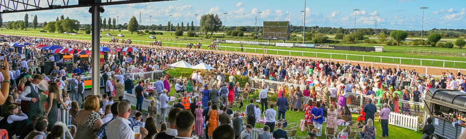 The view from the grandstands at Southwell out over the crowds on a sunny day